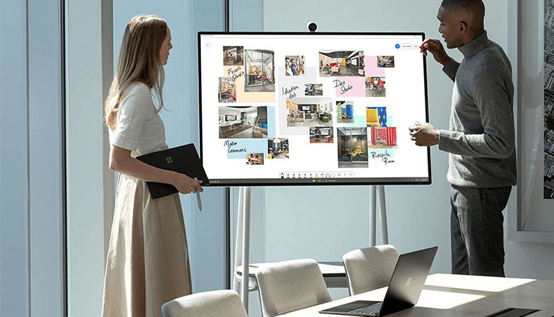Two people work together in the Whiteboard App at the Surface Hub 