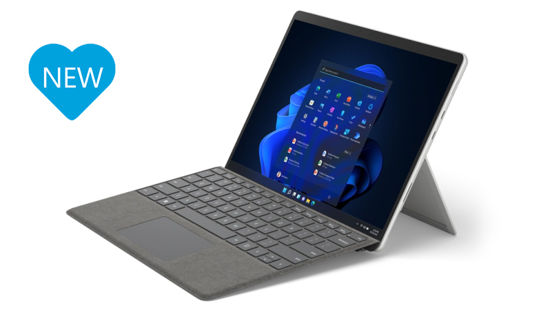 The Surface Pro 8 in platinum from a lateral perspective with Surface Pro Signature Keyboard with a blue heart that says NEW on the left next to the Surface device 