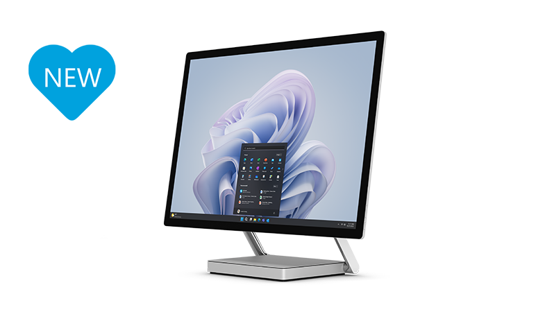 The Surface Studio 2+ from a lateral perspective with keyboard and mouse