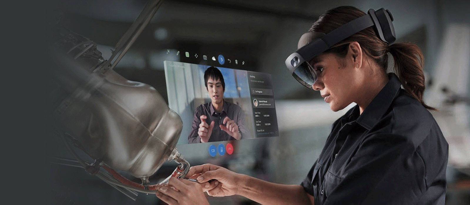 A woman is wearing the HoloLens 2 on her head and looks down