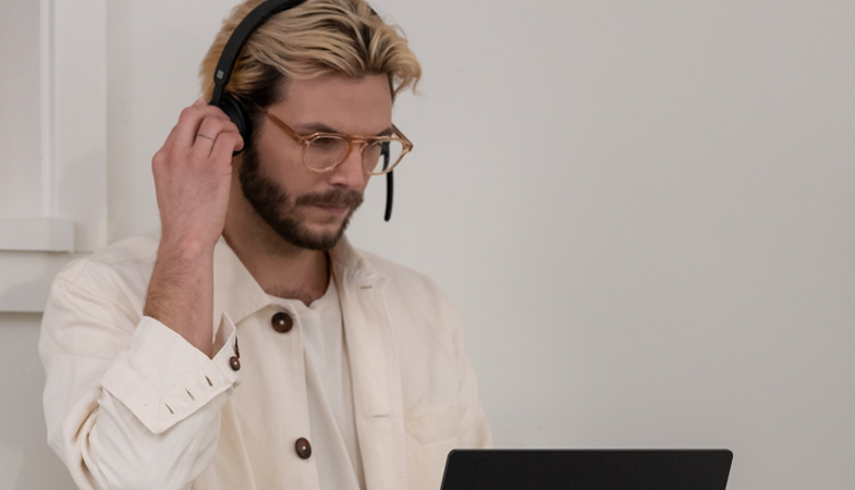 A person wears the Microsoft Modern Wireless Headset at the workplace