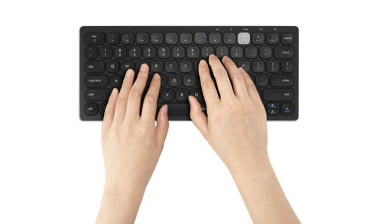 Person tippt auf Multi-Device Dual Wireless Compact Keyboard 