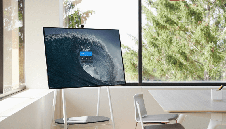 The Surface Hub 2S is standing on the Steelcase Roam Mobile Stand in an office room