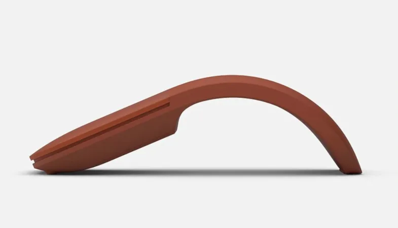 A side view of the Surface Arc Mouse in poppy red