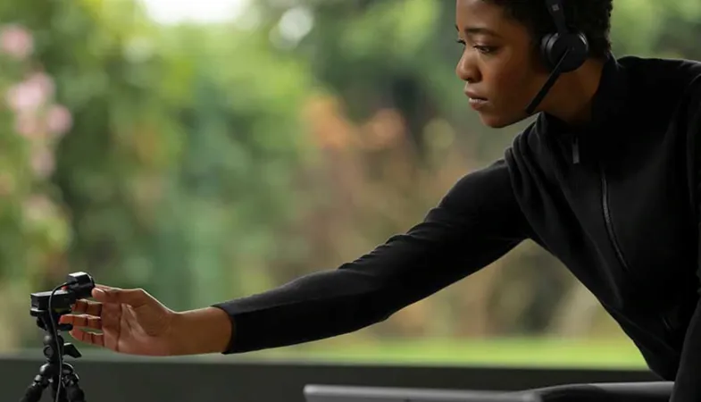 A person posititons the Microsoft Modern Webcam