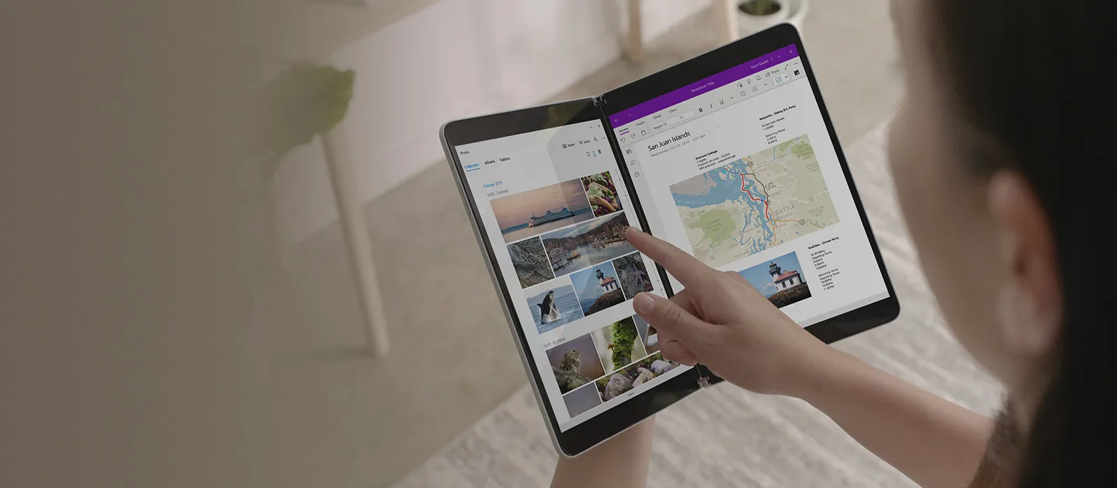 Redefining productivity: Surface Neo A woman holds the Surface Neo open in her hand and taps on the display with her finger