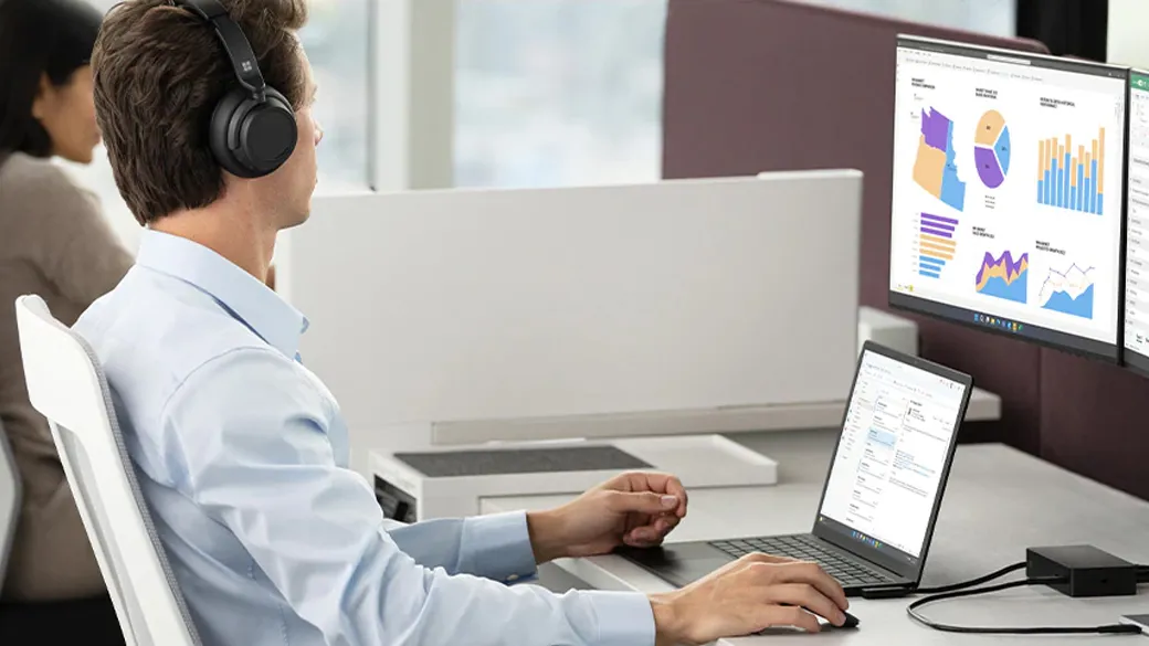 Surface Laptop 5 offers reliable multi-tasking across various applications A man is working on a Surface Laptop 5 with multiple tabs
