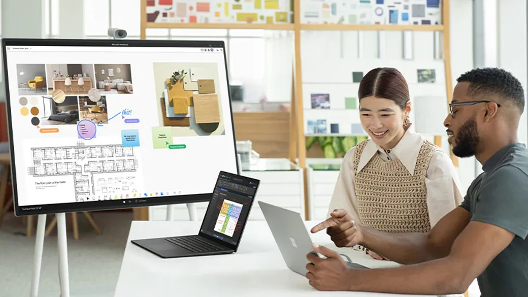Surface Laptop 5 offers powerful performance even on multiple screens A man and woman work together on a Surface Laptop 5 connected to a Surface Hub 2S