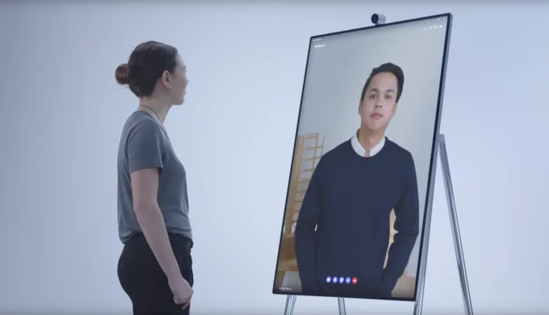 A person is using the Surface Hub 2S with the Surface Hub 2 Camera for a video call