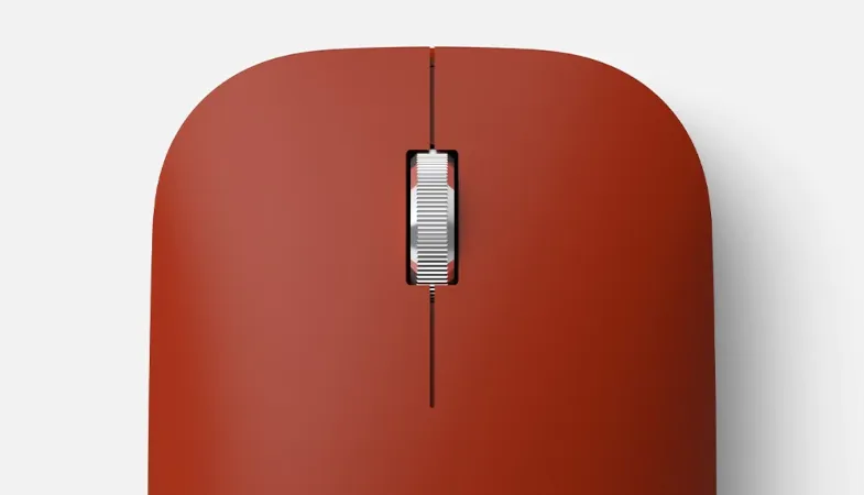 A detailed view of the Surface Mobile Mouse in poppy red 