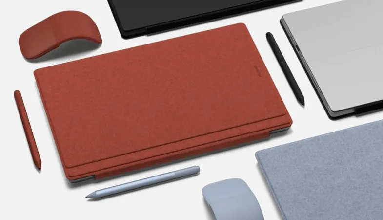  Surface Signature Type Cover, Surface Pen and Surface Arc Mouse in different colours are geometrically arranged
