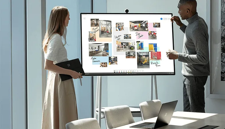 Surface.Love advantage teamwork Two people work together in the Whiteboard App at the Surface Hub