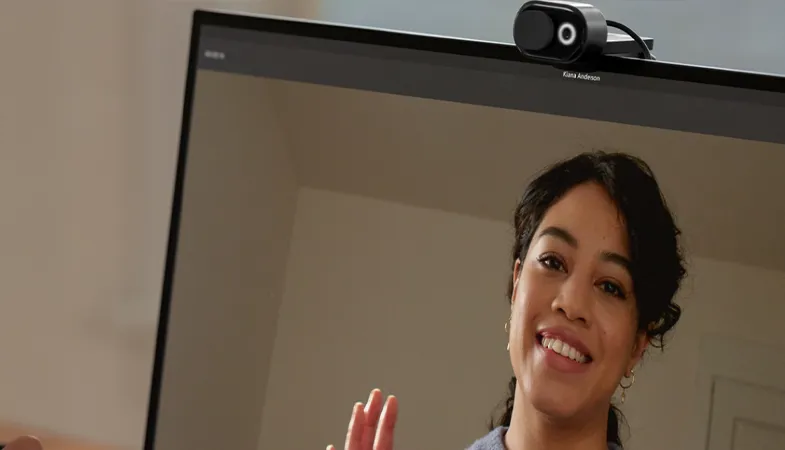 A person holds a video conference with the Microsoft Modern Webcam