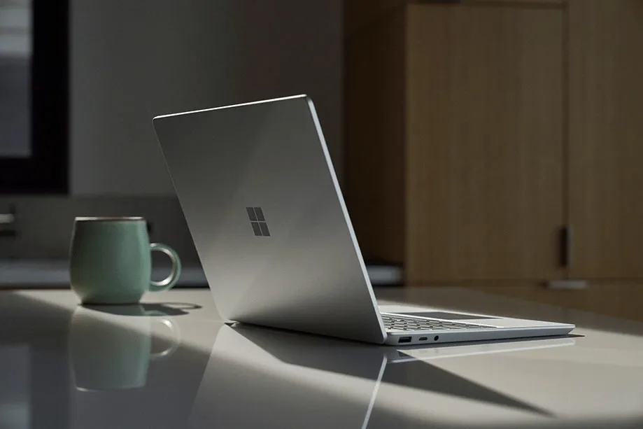  Bird's eye view of three Surface Laptop Go 2 devices in the colours ice blue, sandstone and platinum