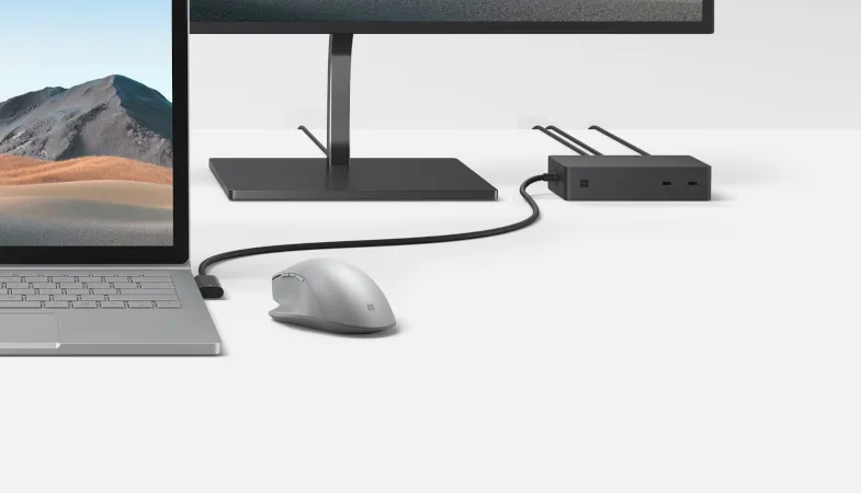 The Surface Dock 2 is connected to a Surface Book 3 and a monitor